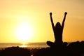 Excited euphoric woman looking sun at sunrise