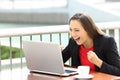 Excited executive reading notification in a laptop Royalty Free Stock Photo