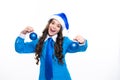 Excited face. Happy Christmas and New Year. Teenage girl in a Santa hat hold christmas ball bauble. Christmas kids