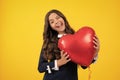 Excited face. Young teenager child girl with heart shape balloon. Happy Valentines Day. Love and pleasant feelings Royalty Free Stock Photo