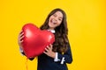 Excited face. Young teenager child girl with heart shape balloon. Happy Valentines Day. Love and pleasant feelings Royalty Free Stock Photo