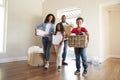 Excited Family Carrying Boxes Into New Home On Moving Day Royalty Free Stock Photo