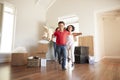 Excited Family Carrying Boxes Into New Home On Moving Day Royalty Free Stock Photo