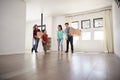 Excited Family Carrying Boxes Into New Home On Moving Day Royalty Free Stock Photo