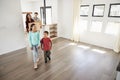 Excited Family Carrying Boxes Into New Home On Moving Day Royalty Free Stock Photo