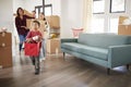 Excited Family Carrying Boxes Into New Home On Moving Day Royalty Free Stock Photo