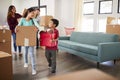 Excited Family Carrying Boxes Into New Home On Moving Day Royalty Free Stock Photo