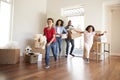 Excited Family Carrying Boxes Into New Home On Moving Day Royalty Free Stock Photo