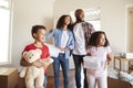 Excited Family Carrying Boxes Into New Home On Moving Day Royalty Free Stock Photo