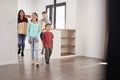 Excited Family Carrying Boxes Into New Home On Moving Day Royalty Free Stock Photo