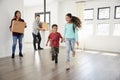 Excited Family Carrying Boxes Into New Home On Moving Day Royalty Free Stock Photo