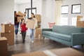 Excited Family Carrying Boxes Into New Home On Moving Day Royalty Free Stock Photo