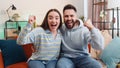 Excited family couple surprised, shocked by sudden victory, good win news, celebrating, wow reaction Royalty Free Stock Photo