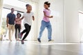 Excited Family Exploring New Home On Moving Day