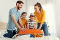 Excited family packing baggage on bed anticipating trip Royalty Free Stock Photo