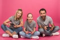 excited family playing video game with joysticks, isolated