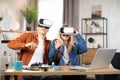 Excited family using VR glasses for playing games at home Royalty Free Stock Photo