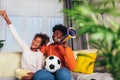Fmily watching football match at home. Mother and daughter having fun at home Royalty Free Stock Photo