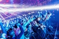 Excited fans having fun during a pop music festival under the flashing lights