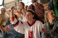 Excited fans supproting Slovak national team in live match at stadium.