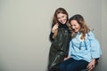 Excited fashionable young women having fun together. Two cute girls best friends smiling and embracing. Happy women talking and la Royalty Free Stock Photo