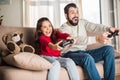 excited father and daughter playing video game Royalty Free Stock Photo