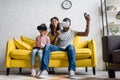 excited father and daughter playing video games while mother sitting behind Royalty Free Stock Photo