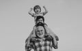 Excited. Father and son playing outdoors. Happy smiling boy on shoulder dad looking at camera. Happy family. Three men Royalty Free Stock Photo