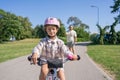 Excited father teaching girl to ride a bike, summer fun and park outdoors. Happy kid, learning and riding bicycle with Royalty Free Stock Photo