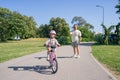 Excited father teaching girl to ride a bike, summer fun and park outdoors. Happy kid, learning and riding bicycle with Royalty Free Stock Photo