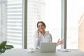 Smiling businesswoman happily talking over phone with friend Royalty Free Stock Photo