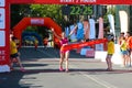 Excited female runner crossing the finshline of a marathon