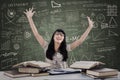 Excited female student in class with books Royalty Free Stock Photo