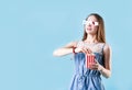 Excited female teenager girl wearing 3D glasses eating popcorn isolated on blue background Royalty Free Stock Photo