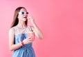Excited female teenager girl wearing 3D glasses eating popcorn isolated on pink background Royalty Free Stock Photo