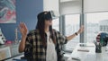 Excited freelancer immersing virtual reality at flat. Woman touching metaverse