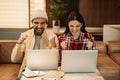 excited freelancers using laptops and smiling