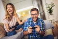 Excited funny couple playing video games at home Royalty Free Stock Photo