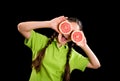 Excited funny girl with sliced grapefruit on eyes