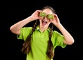 Excited funny girl with sliced kiwi on eyes