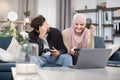 Excited funny multiehnic Muslim couple having fun together while playing video games at home. Laughing woman in hijab Royalty Free Stock Photo