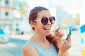 Excited funny young woman raising her finger about to push the button on her cell phone looking at you camera Royalty Free Stock Photo