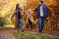 Excited Girl Being Swung By Parents On Family Autumn Walk Through Countryside Royalty Free Stock Photo