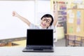 Excited girl celebrate her victory with laptop in class Royalty Free Stock Photo