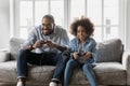 Excited girl and her dad playing video games together Royalty Free Stock Photo