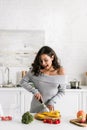 Girl holding knife near paprika and cutting board Royalty Free Stock Photo