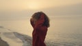 Excited girl jumping on beach. Smiling woman turning around on sea coast Royalty Free Stock Photo