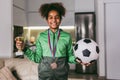 Girl with medals and trophy cup