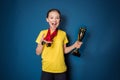 Excited girl with medals and trophy cup Royalty Free Stock Photo