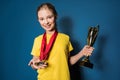 Excited girl with medals and trophy cup Royalty Free Stock Photo